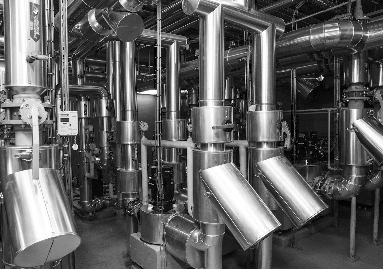 Insulated stainless steel process pipework in a plant room